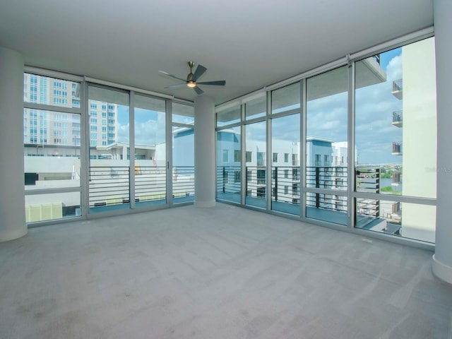 interior space with floor to ceiling windows and ceiling fan