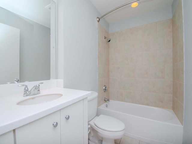 full bathroom featuring tiled shower / bath, vanity, tile patterned flooring, and toilet