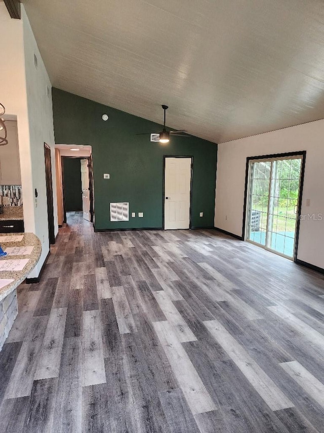 spare room with vaulted ceiling, ceiling fan, and hardwood / wood-style floors