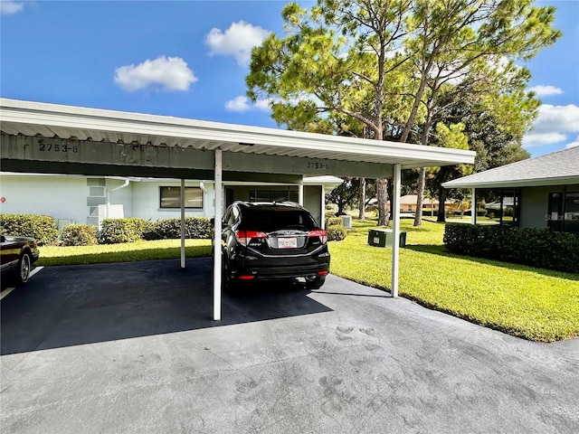 view of vehicle parking featuring a yard and a carport