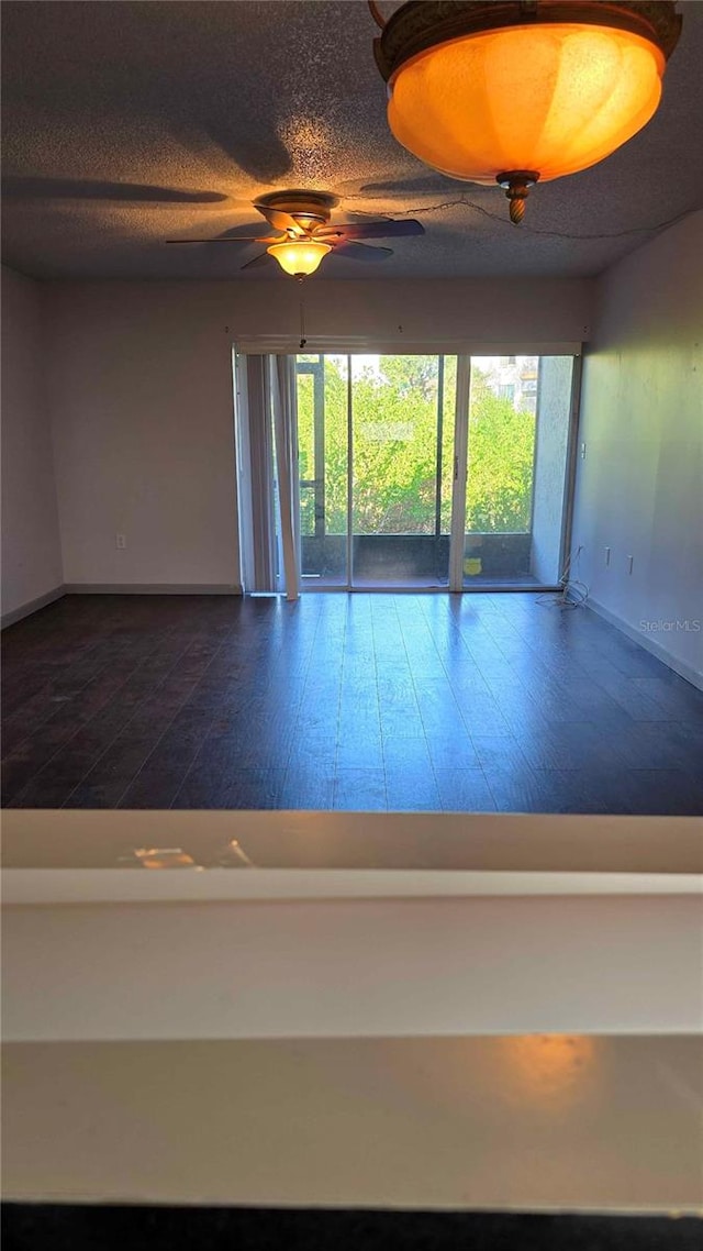 empty room featuring hardwood / wood-style floors and ceiling fan