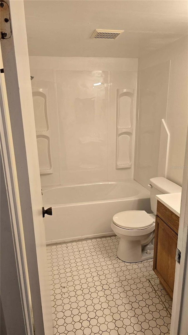 full bathroom featuring bathing tub / shower combination, vanity, and toilet