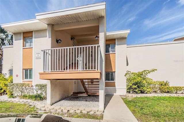 exterior space with stucco siding and stairs