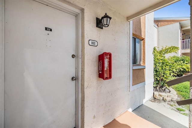 view of exterior entry with stucco siding