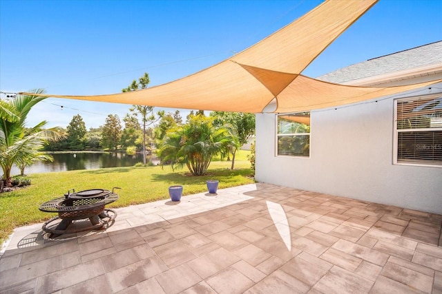 view of patio / terrace featuring a water view and an outdoor fire pit