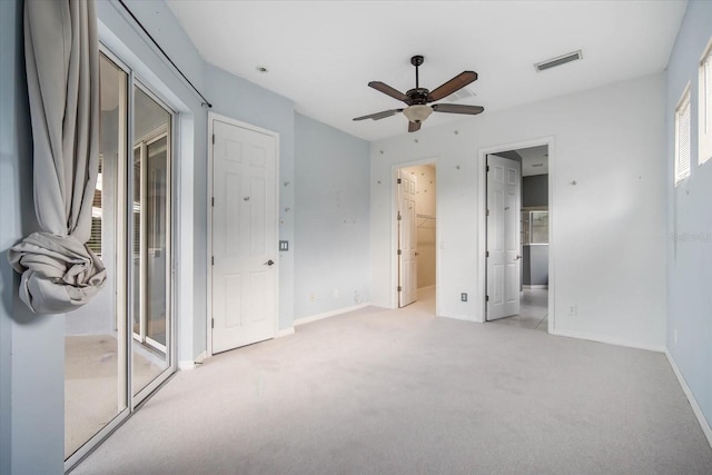 unfurnished bedroom featuring ceiling fan, a closet, and light colored carpet