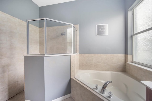 bathroom featuring shower with separate bathtub and tile patterned flooring