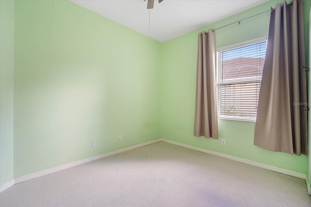 unfurnished room with light colored carpet and ceiling fan