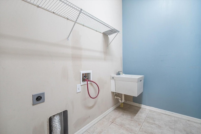 laundry room featuring washer hookup, sink, light tile patterned floors, and hookup for an electric dryer