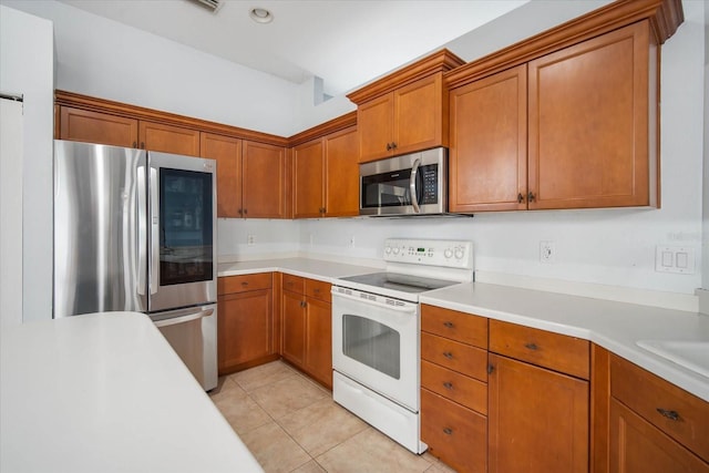 kitchen with stainless steel appliances and light tile patterned floors