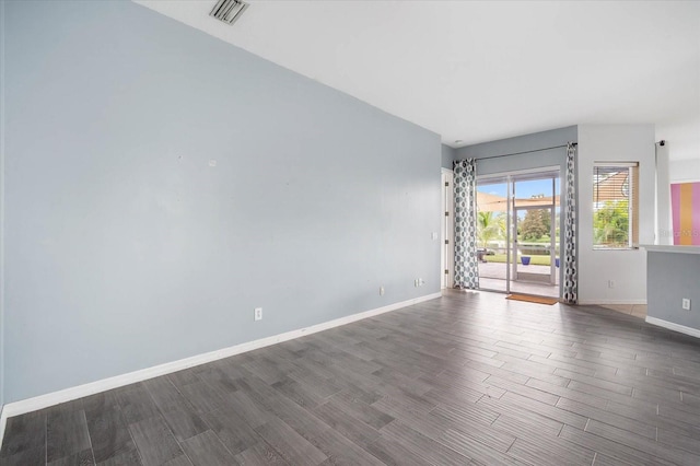 spare room featuring dark hardwood / wood-style flooring