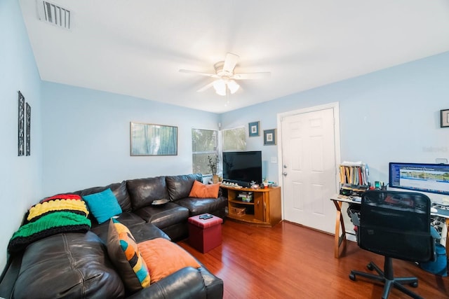 living room featuring ceiling fan and hardwood / wood-style floors