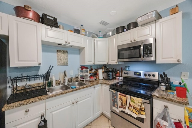 kitchen with white cabinets, stainless steel appliances, and sink