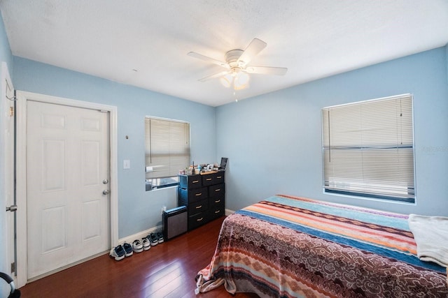 bedroom featuring ceiling fan and dark hardwood / wood-style flooring