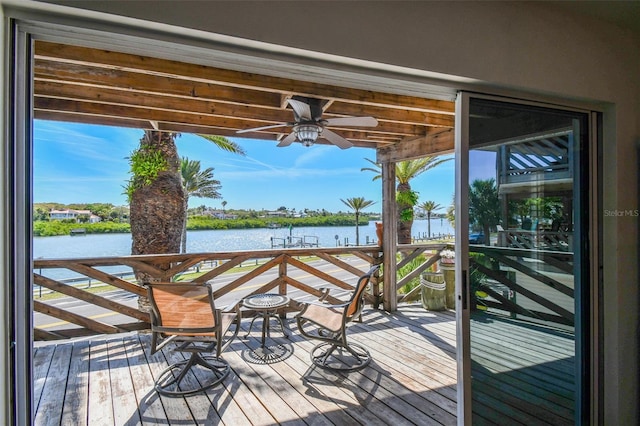 deck featuring a water view and ceiling fan