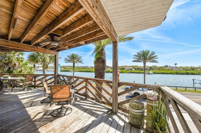 wooden terrace with ceiling fan and a water view