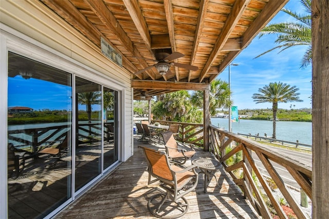 exterior space with a water view and ceiling fan