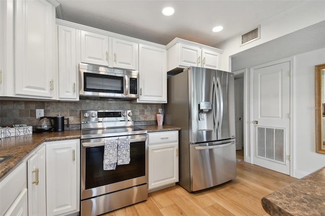 kitchen featuring light hardwood / wood-style floors, white cabinetry, and stainless steel appliances