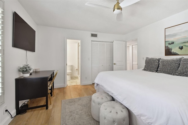 bedroom with light hardwood / wood-style flooring, ceiling fan, and ensuite bathroom