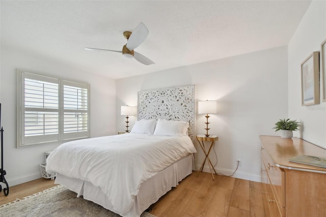 bedroom featuring light wood-type flooring and ceiling fan