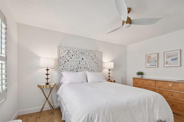 bedroom featuring light hardwood / wood-style floors and ceiling fan