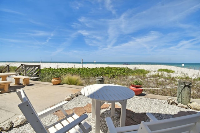 view of patio / terrace featuring a view of the beach and a water view