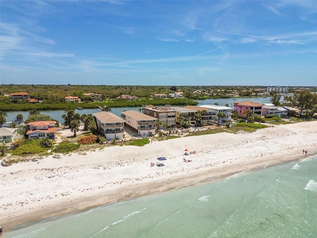 drone / aerial view with a water view and a beach view