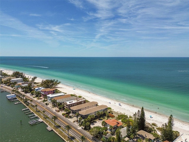 aerial view with a water view and a beach view