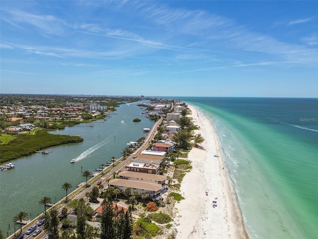 birds eye view of property with a water view and a beach view