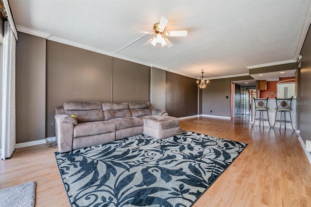 living room with a textured ceiling, ceiling fan with notable chandelier, crown molding, and light hardwood / wood-style floors