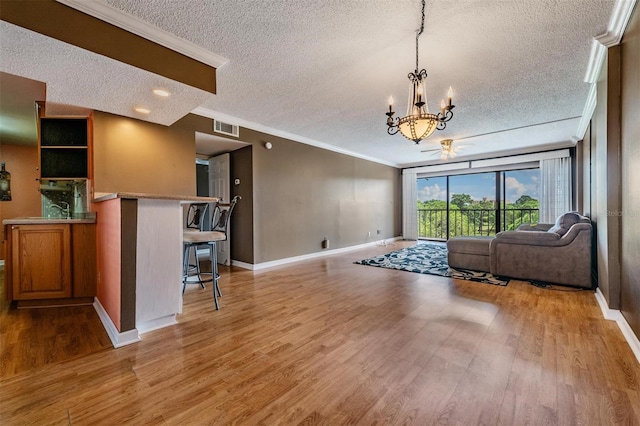 unfurnished living room with wood-type flooring and a textured ceiling