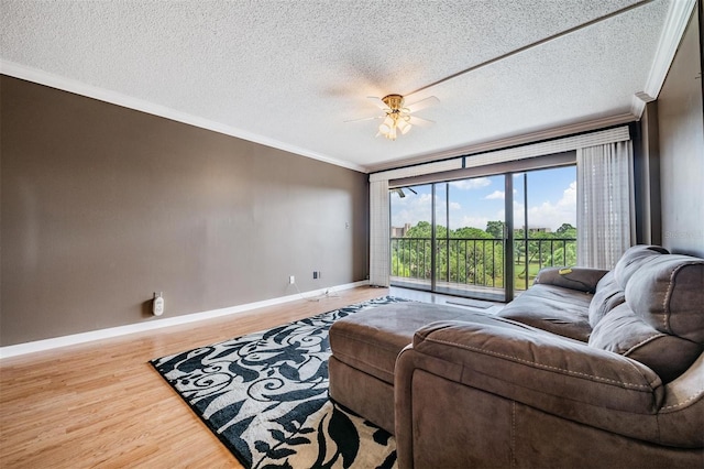 living room with a textured ceiling, crown molding, ceiling fan, and hardwood / wood-style flooring