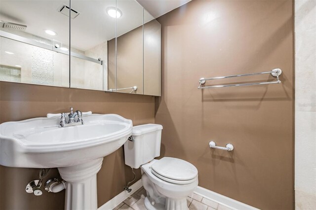 bathroom featuring walk in shower and toilet