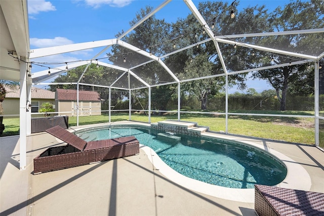 view of swimming pool with a storage unit, a patio, a lawn, and a lanai