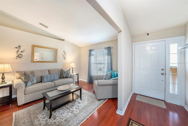 living room featuring lofted ceiling and dark wood-type flooring