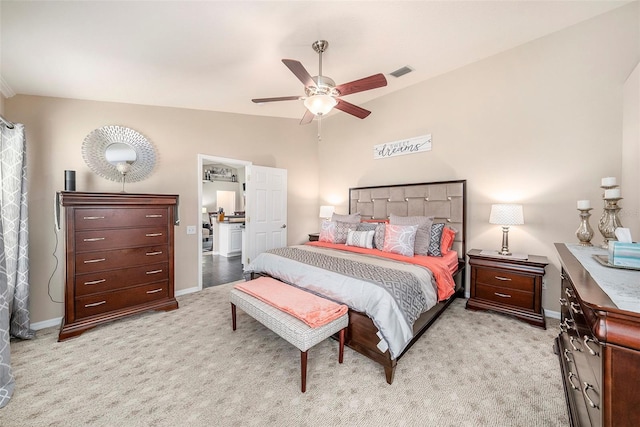 bedroom with vaulted ceiling, light carpet, and ceiling fan