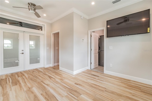 empty room with ceiling fan, light wood-type flooring, french doors, and ornamental molding