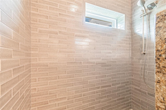 interior details with a tile shower