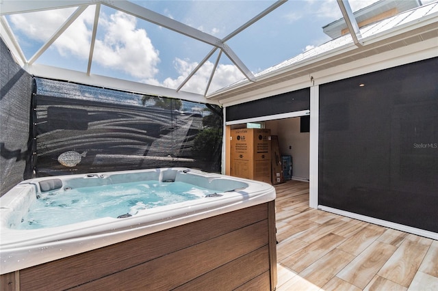 exterior space featuring a wooden deck, a hot tub, and glass enclosure