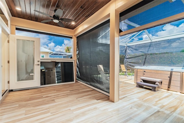 deck featuring a lanai, a hot tub, and ceiling fan