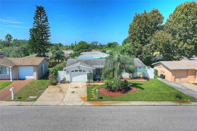 ranch-style house with a garage and a front lawn