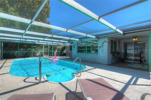 outdoor pool with a lanai and a patio