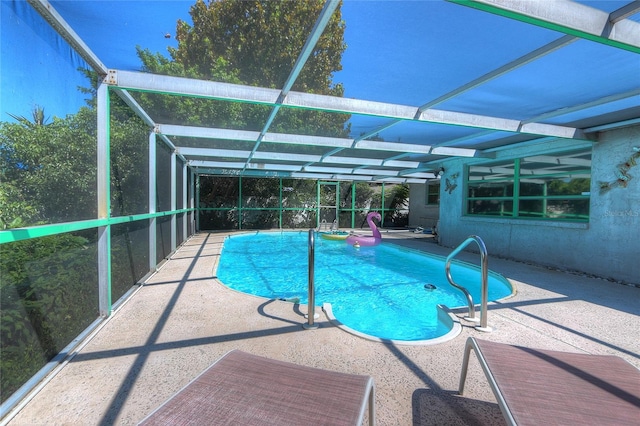 pool featuring a patio and glass enclosure