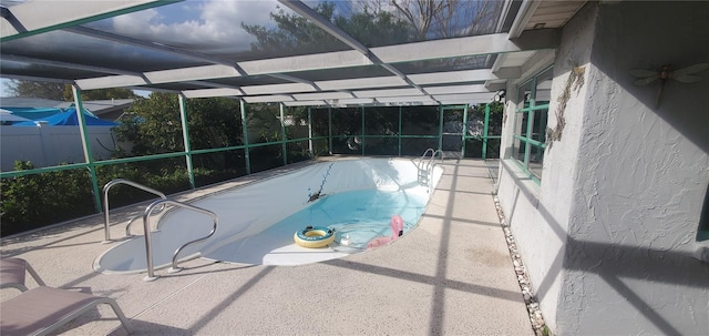 view of pool with a lanai and a patio