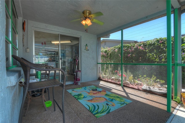 sunroom / solarium with a ceiling fan