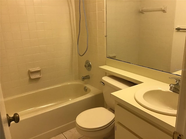 full bathroom with vanity, tile patterned flooring, tiled shower / bath, and toilet