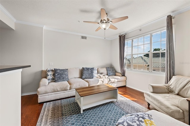 living room featuring ornamental molding, ceiling fan, dark hardwood / wood-style floors, and a textured ceiling