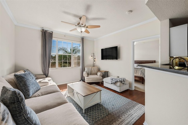 living room featuring ceiling fan, crown molding, and dark hardwood / wood-style flooring