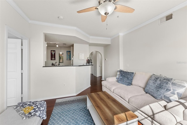 living room with ceiling fan, ornamental molding, sink, and dark hardwood / wood-style flooring