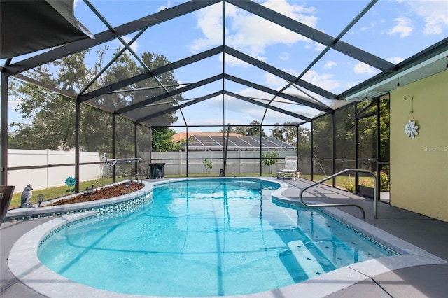 view of swimming pool featuring a lanai